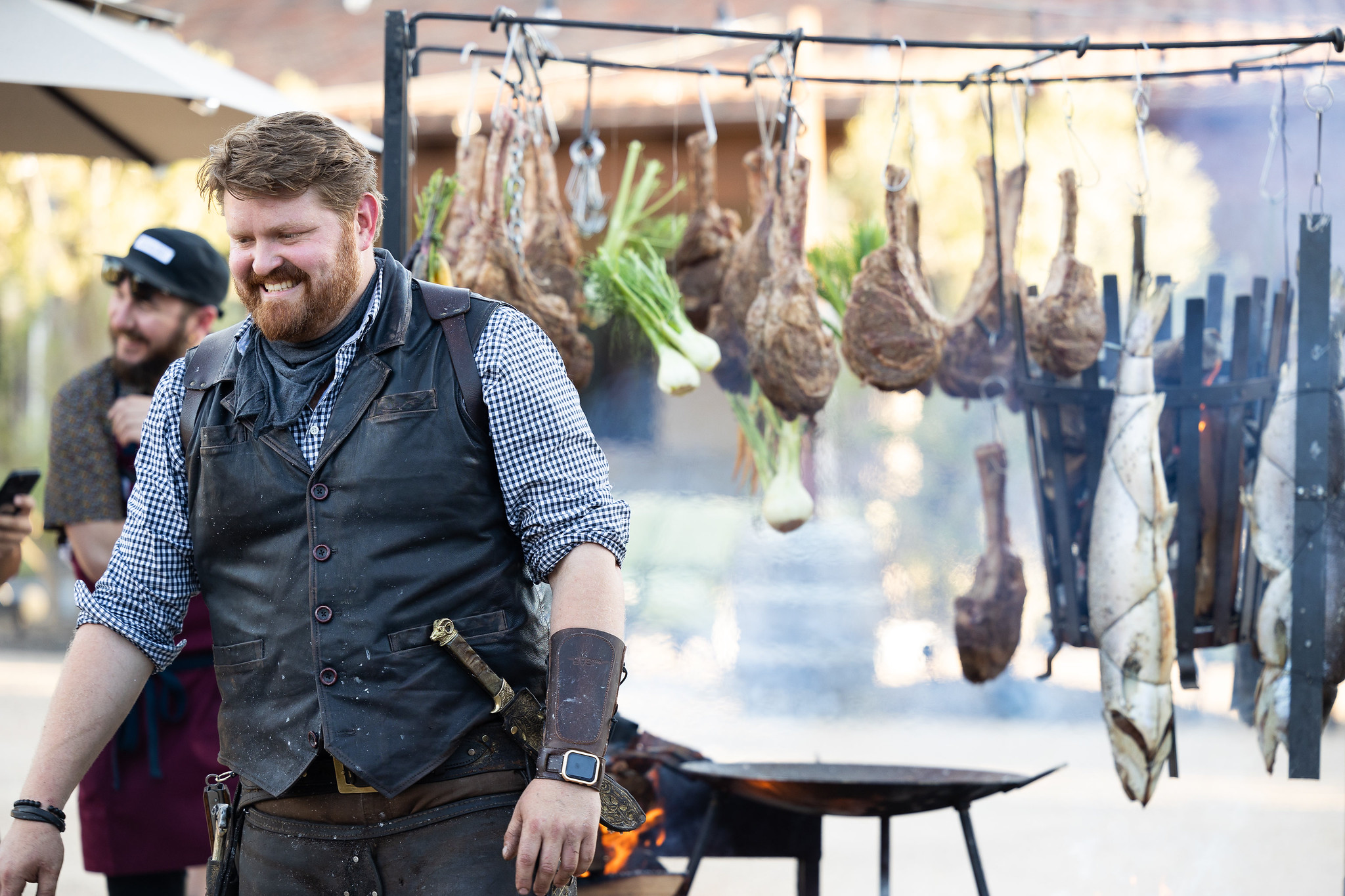 Chef smiling before the fire